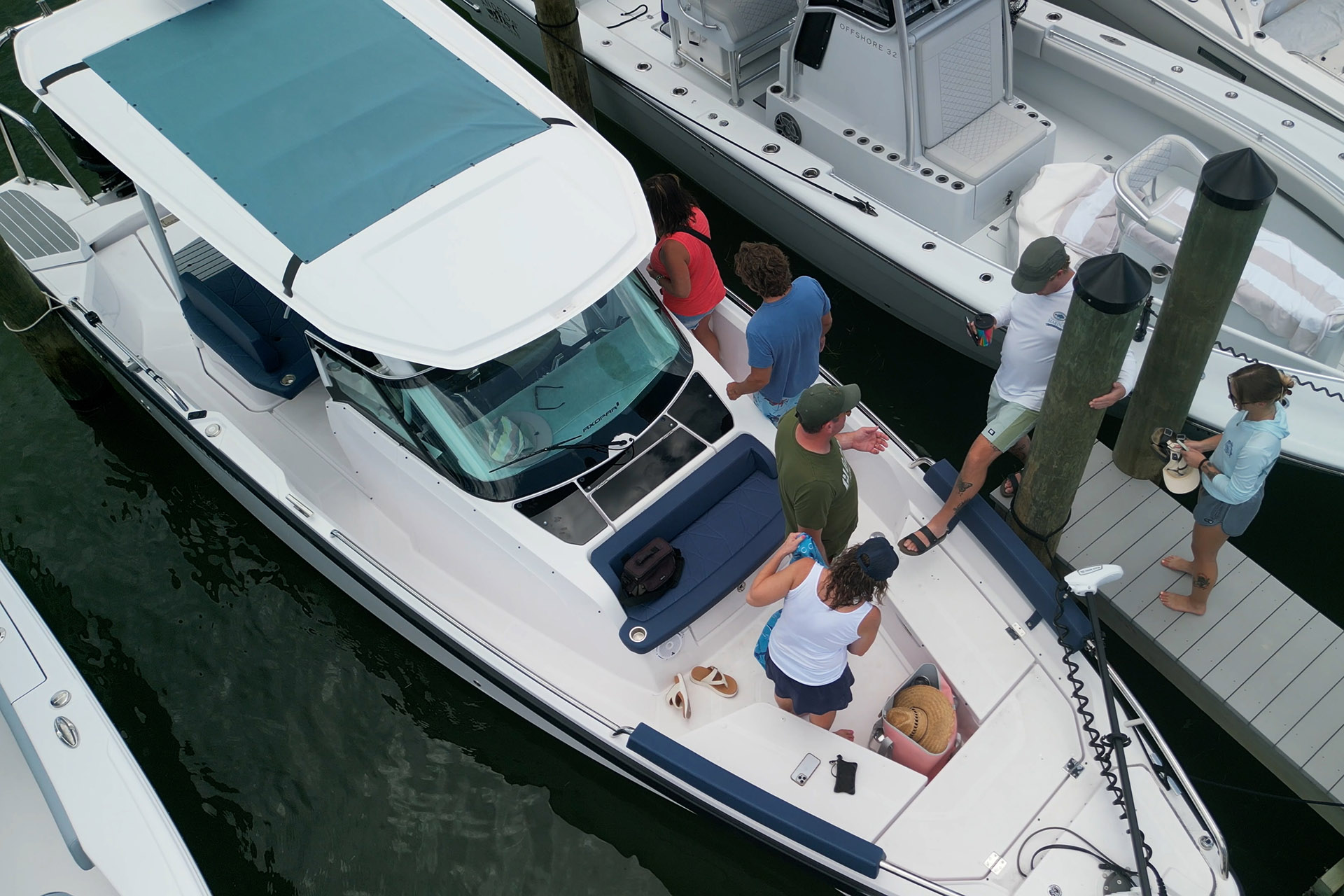 Guests Arriving by Boat for a Waterfront Dining Cruise | Florida Gulf Discovery Guests boarding and departing Captain Pavel's Axopar 29 at a Southwest Florida marina during a private waterfront dining cruise.