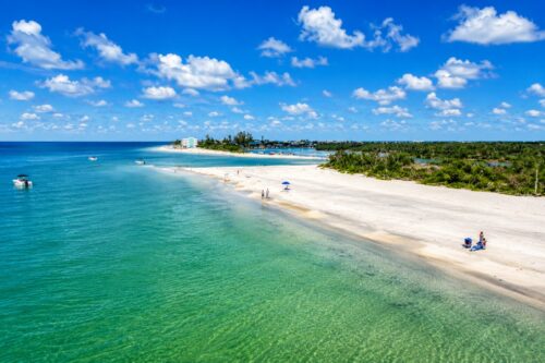 Gulf-side view of Milton Pass at southern Manasota Key on September 20, 2025, showing the broad sandy shoreline, Gulf waters, beach visitors, and evolving inlet.