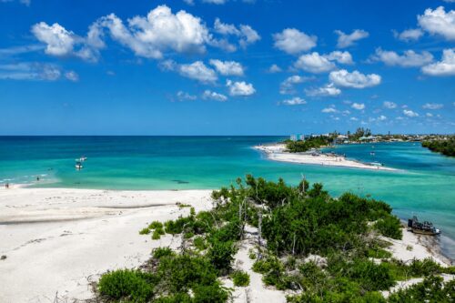 Milton Pass at Manasota Key on September 20, 2025, showing turquoise Gulf water, sandy shorelines, boats, and the inlet created by Hurricane Milton.