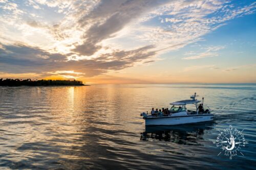 Florida Gulf Discovery private family boat tour cruising through Boca Grande Pass on the return from Cabbage Key at sunset.