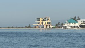 Modern waterfront home near Bird Key sandbar and Small Gasparilla Island viewed during a private boat trip through Gasparilla Pass in Southwest Florida
