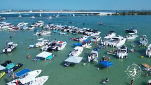 Boats gathered at Boca Grande sandbar near the Boca Grande Causeway bridge in Southwest Florida on a sunny day