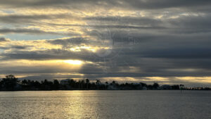 Sunrise breaking through clouds over Cape Haze Florida with calm coastal water during private boat tour with Florida Gulf Discovery