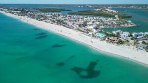 Aerial view of Englewood Beach and Manasota Key Florida with turquoise Gulf waters, white sand shoreline, waterfront resorts, marinas, and coastal neighborhoods