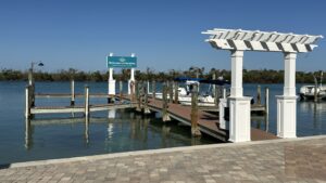 Private marina docks and waterfront entrance at Manasota Key Resort on Lemon Bay in Englewood Florida with calm coastal water and tropical scenery