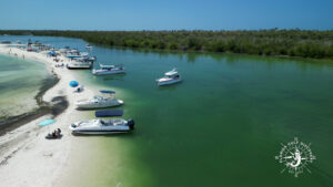 Boats anchored along the sandy shoreline at Pelican Bay Lagoon near Cayo Costa during a private Southwest Florida boat trip