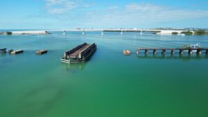 Aerial view of Placida trestle ruins and Boca Grande Causeway bridge over Gasparilla Sound Florida during private boat tour with Florida Gulf Discovery