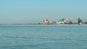 View across calm coastal waters toward homes on Small Gasparilla Island near Gasparilla Pass in Southwest Florida