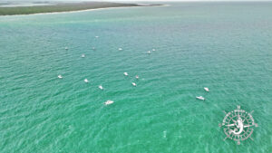 Aerial drone view of boats gathered over the tarpon fishing grounds at Boca Grande Pass near Gasparilla Island, Florida.