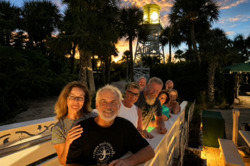 Guests gather beneath the historic Cabbage Key Water Tower before dinner at sunset during a private boat tour with Captain Pavel.