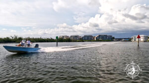 Boat running through Gasparilla Pass near Boca Grande under dramatic summer clouds while returning home.