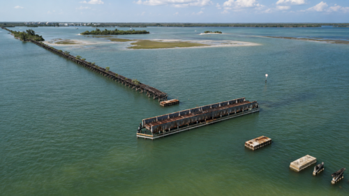 Drone view of the Historic Placida Trestle, Gasparilla Sound, and surrounding sandbars in Placida, Florida.