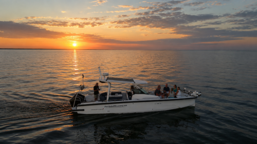 Sunset cruise aboard an Axopar 29 in Southwest Florida with guests enjoying calm Gulf waters at sunset.