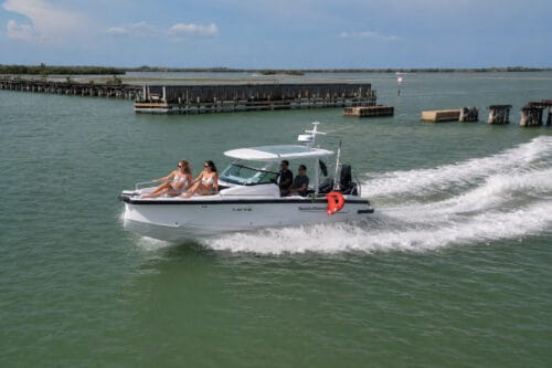 Captain Pavel's Axopar 29 cruising past the historic Placida Trestle toward Gasparilla Pass during a private boat tour in Southwest Florida.