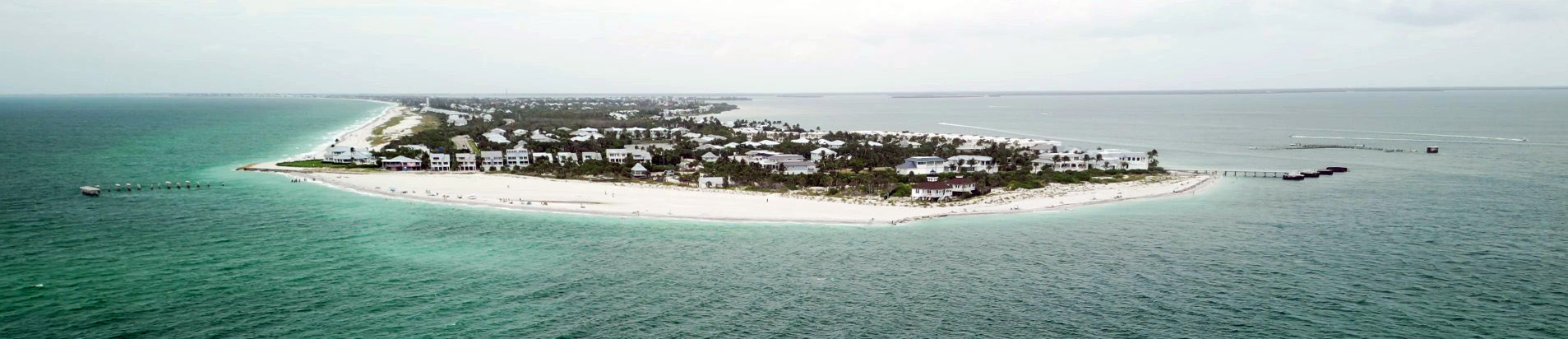 Panoramic aerial view of the south end of Gasparilla Island, Boca Grande Pass, and the historic phosphate dock remains in Southwest Florida.