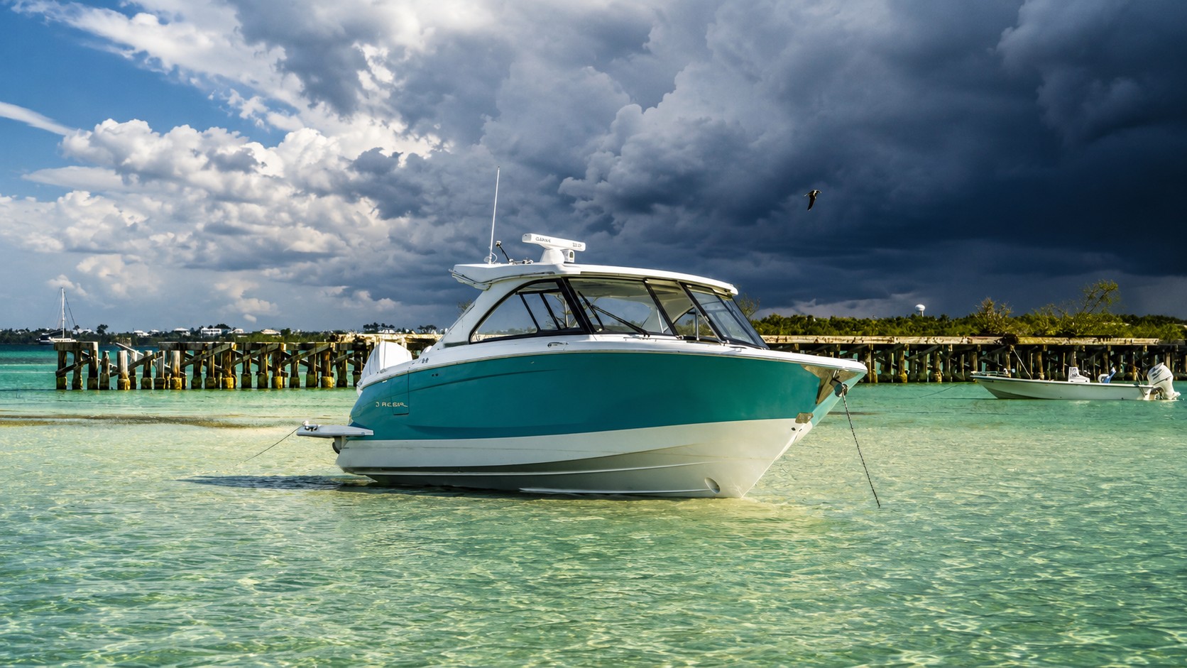Anchored boat at Boca Grande Sandbar with changing tides in Southwest Florida