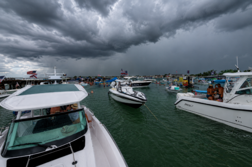 Dark thunderstorm clouds approaching Boca Grande Sandbar as dozens of boats remain anchored during the July 4, 2026 Independence Day celebration in Southwest Florida.