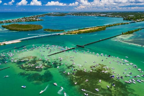 Aerial drone view of hundreds of boats gathered for The Boca Sandbar Freedom Fest during the 2026 Independence Day celebration at Boca Grande Sandbar, Florida.