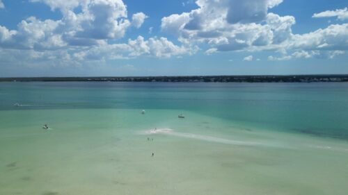 Aerial view of Bokeelia Sandbar in Pine Island Sound with shallow turquoise water and boats near Bokeelia, Florida.