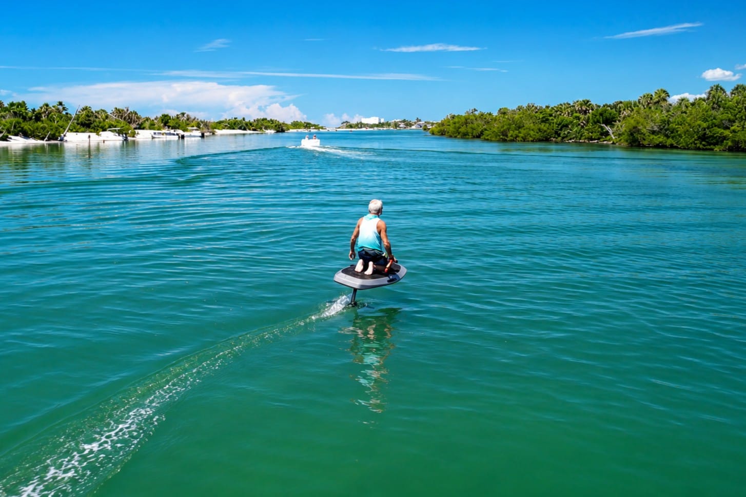 Captain Pavel riding an e-foil through the calm waters of Ski Alley near Stump Pass and Lemon Bay in Southwest Florida.