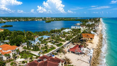 Aerial view of Casey Key, Florida, showing beachfront homes and shoreline conditions several months after a major hurricane.