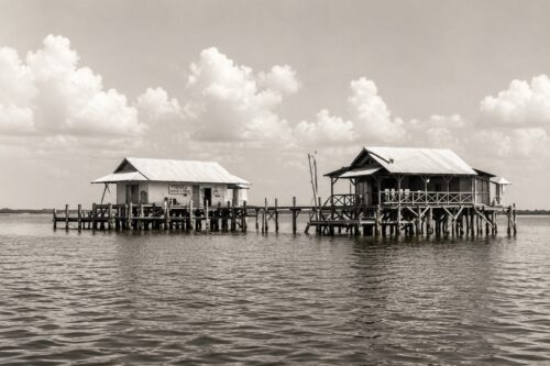 Historic fishing camps built on pilings over Pine Island Sound in Southwest Florida, supporting the region's commercial fishing industry.