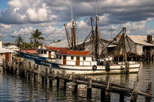 Historic shrimp fishing boats moored at the Boca Grande waterfront during the twentieth century, reflecting the island's commercial fishing heritage.