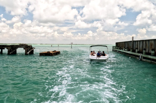 Boat passing through the historic Placida Trestle channel into Gasparilla Sound near Boca Grande Sandbar, Southwest Florida.