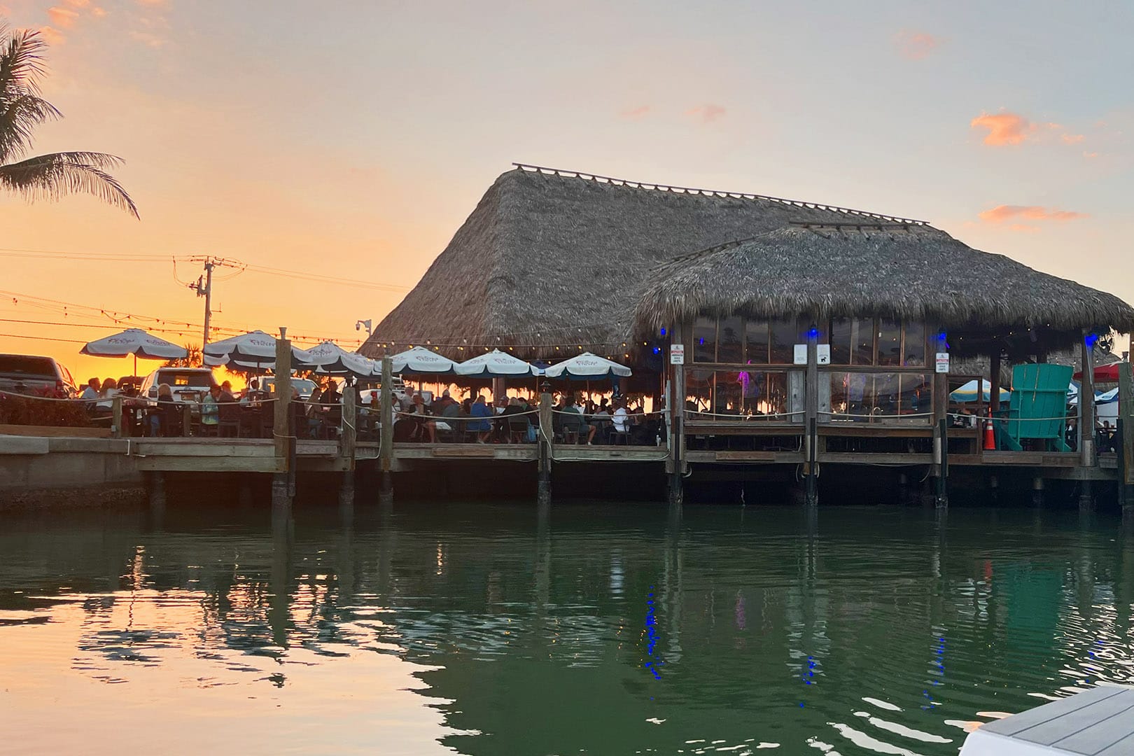 Sunset at SandBar Tiki & Grille overlooking Lemon Bay on Manasota Key, Florida
