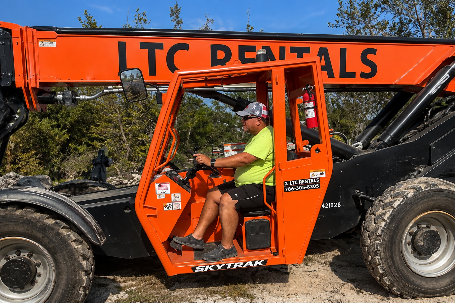 Brian Turner of Big Boy Toyz Productions operating a SkyTrak telehandler while preparing equipment for Boca H2O Music Festival
