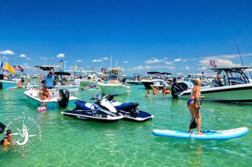 Memorial Day boating crowd at Boca Grande Sandbar with boats, paddleboard, and turquoise water in Southwest Florida.