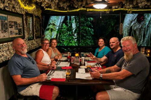 Family boat trip enjoying dinner at Cabbage Key Inn & Restaurant in Southwest Florida with Florida Gulf Discovery.