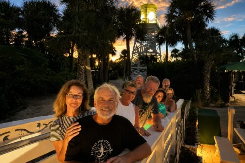 Guests at the historic Cabbage Key water tower at sunset during a private boat trip with Florida Gulf Discovery.