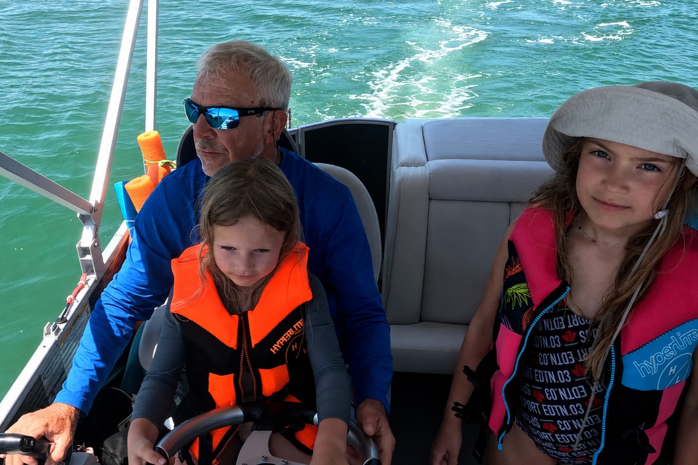 Captain Pavel with children wearing life jackets aboard a private boat tour in Southwest Florida